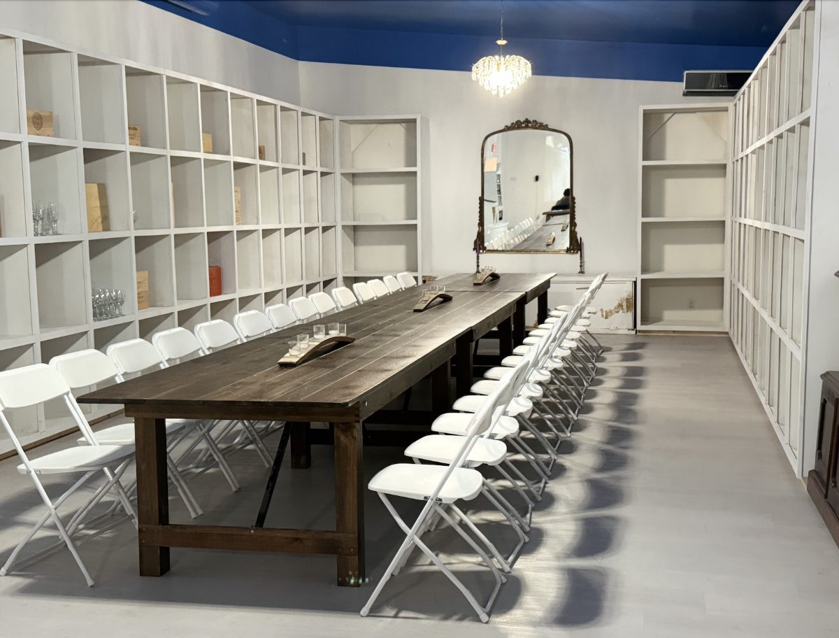 Inside Vino, the long communal tasting table and shelves on Oak Street, New Orleans